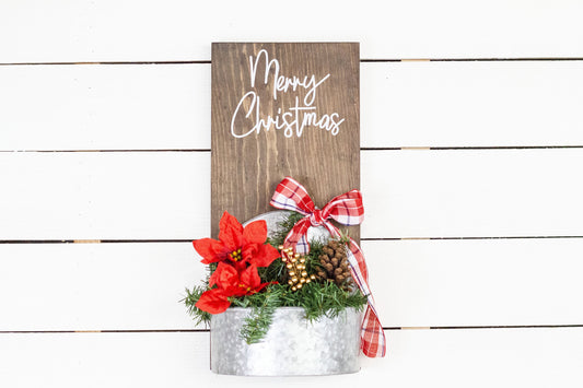 Rustic pine wood wall sign with festive greenery and metal planter
