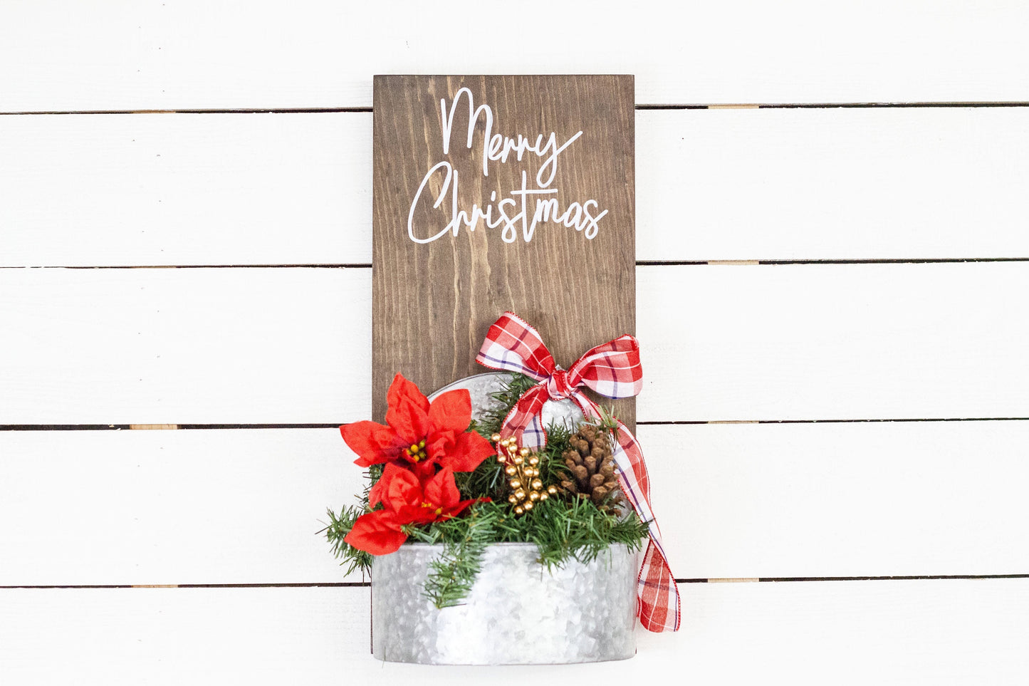 Rustic pine wood wall sign with festive greenery and metal planter