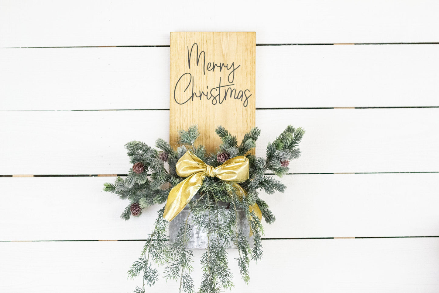 Rustic pine wood wall sign with festive greenery and metal planter