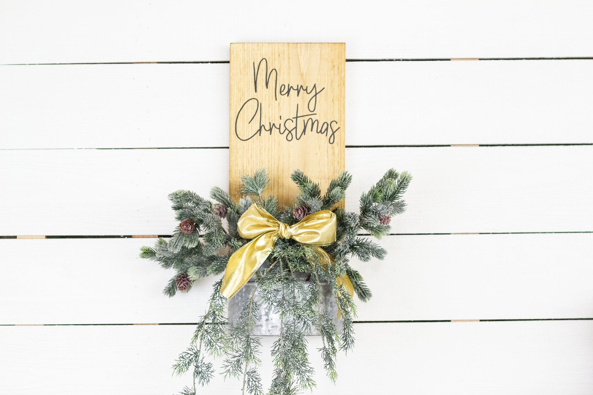 Rustic pine wood wall sign with festive greenery and metal planter