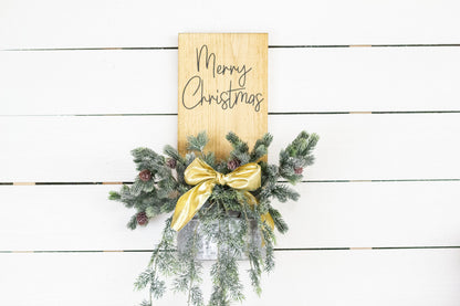 Rustic pine wood wall sign with festive greenery and metal planter