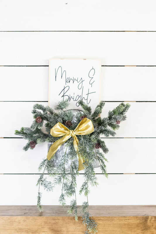 Rustic pine wood wall sign with festive greenery and metal planter